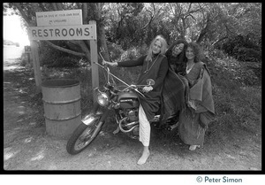 Drapeti, Cathy Brown (Usha), and Leenda seated on a motorcycle at Stinson Beach