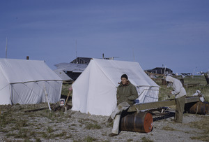 Helge Larsen relaxes outside a tent.