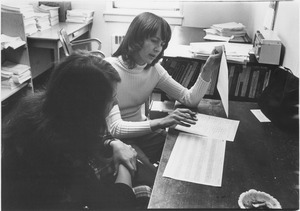 Dr. Alice H. Eagly sitting indoors, in office, working with student