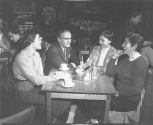Jean Paul Mather sitting with students