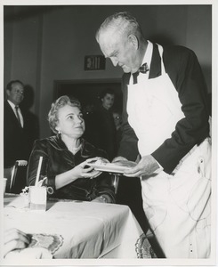 Bruce F. Barton handing plate to woman