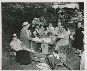 People enjoying lunch outside during annual outing