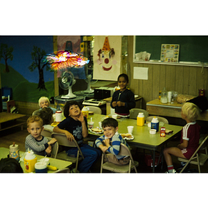 Young children at a table eating a snack