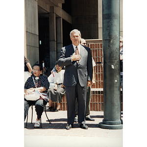 Mayor Thomas Menino stands with his hand to his chest