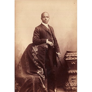 An African American man in formal dress with a cane