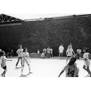 Women playing volleyball.