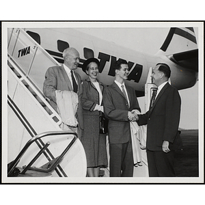 Richard J. O'Neil shakes hands with Paul F. Hellmuth, President of the Boys' Clubs of Boston, while Arthur and Barbara Burger look on