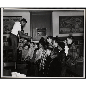 A candidate for Mayor of Boystown gives a speech to a crowd of boys inside Roxbury's Waterman Memorial Library