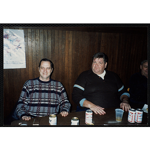 Two Bunker Hillbilly alumni sit at a table during a reunion event