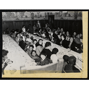 Women and boys sit at long tables during a Womens' Club banquet