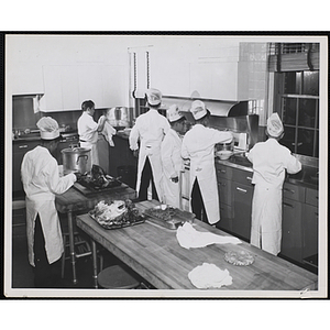 Members of the Tom Pappas Chefs' Club cook in a kitchen