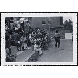 A man addresses a seated group of boys during Tom Sawyer Day