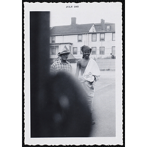 A teenage boy and a man pose for an outdoor shot during Tom Sawyer Day