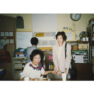 Two women in the Chinese Progressive Association headquarters during the 40th anniversary celebration of the People's Republic of China