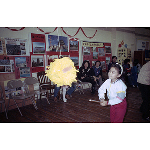 Girl takes a swing at a piñata