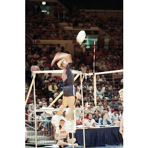 USA Men's Volleyball Team member jumps to hit a ball across the net