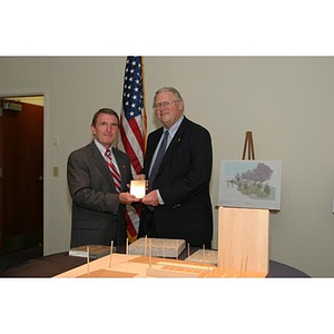 Neal Finnegan poses with another man and a plaque at the Veterans Memorial dinner