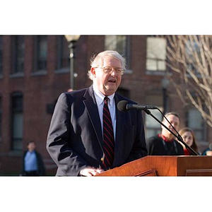 Neal Finnegan speaks at the podium at the Veterans Memorial dedication