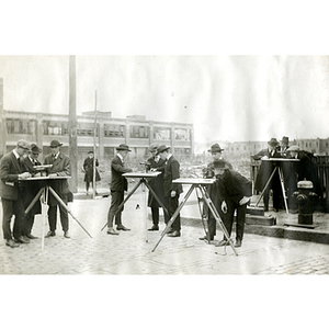 A group of engineering students survey a building site