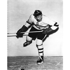 A Northeastern hockey player on the ice preparing to shoot