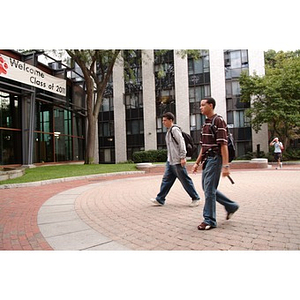 Two male Torch Scholars walk towards Stetson East