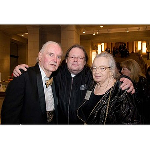 Three people pose together at the inauguration celebration of President Aoun