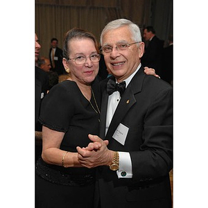 A couple dancing at a dinner honoring members of the Huntington Society