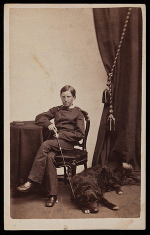 Studio portrait of a young boy and a dog, Boston, Mass., undated