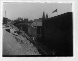 View of construction site between a wall and mound of dirt