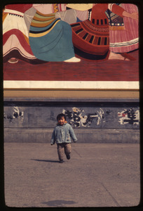 Little child under huge poster