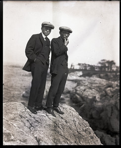 George S. Akasu (left) and unidentified man standing on a rocky shore