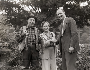 Osa Johnson, holding fish she has caught, with Charles A. Pope and Fred Brown