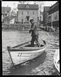 John P. Johnson ("Armless Johnson") working on a small rowboat