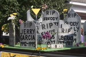 Parade float with tombstones of deceased musicians (Jerry Garcia, Elvis, Liberace, Freddy Mercury, Buddy Holly) : Provincetown Carnival parade