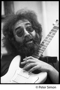 Jerry Garcia: portrait with guitar and cigarette