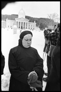 Protester from Bread and Puppet Theater, hands bound and dressed in cloak and mask, during a demonstration against the invasion of Laos