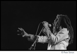 Bob Marley in concert, gesturing to the audience