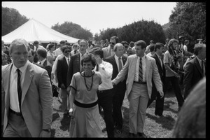 Kitty and Mike Dukakis (hand over face) walking hand-in-hand at the 25th Anniversary of the March on Washington