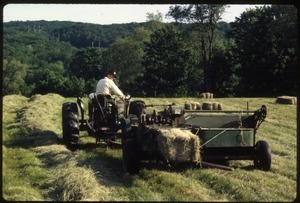 Dan Keller on tractor, baling hay, Wendell Farm