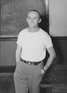 Joseph R. Rogers standing in front of blackboard