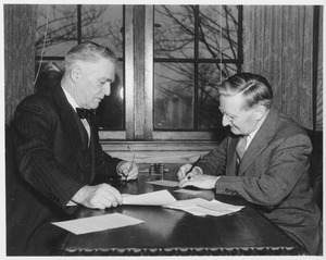 Hugh P. Baker at a desk with William L. Machmer