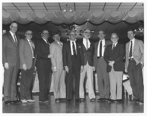 Reuben Trippensee surrounded by faculty members in auditorium