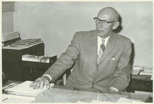 Emory Ellsworth Grayson sitting indoors, behind desk