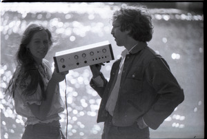 Lacey Mason and Elliot Blinder holding stereo equipment
