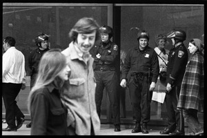 Police watch as antiwar demonstrators picket in front of the John F. Kennedy Federal Building