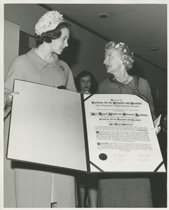 Unidentified woman presenting Princess Benedikte of Denmark with a scroll thanking her for her visit