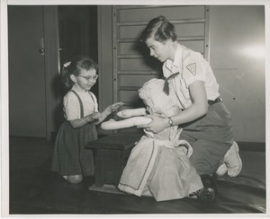 Physical therapist playing with a doll with a child