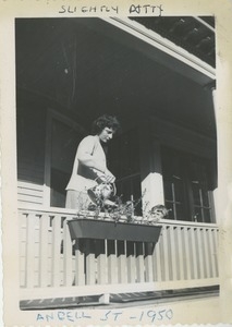 Bernice Kahn watering flowers on porch
