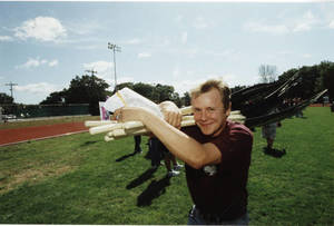 Student carrying rakes on Humanics in Action Day (1998)