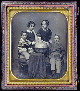 Four children with a globe